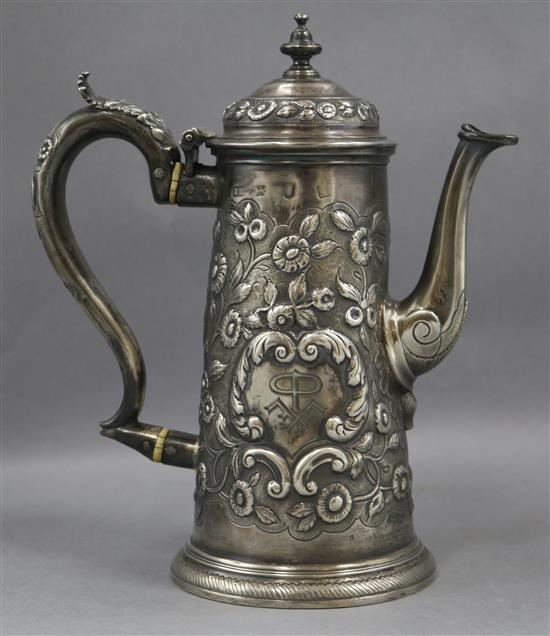 A mid 18th century English silver coffee pot, with later embossed decoration, marks rubbed gross 12.5oz